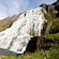 3 people standing near a multi level waterfall